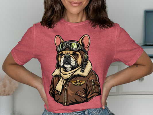 French bulldog wearing aviator goggles and jacket with "CAPTAIN" text.