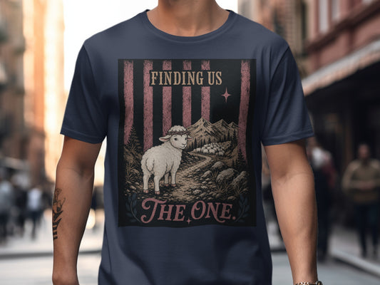 Dark t-shirt featuring a graphic of a sheep with a crown of thorns and text "FINDING US THE ONE."