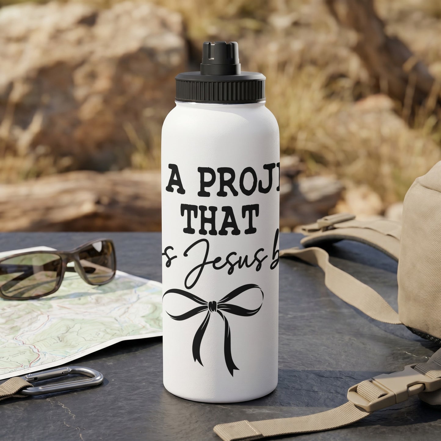 White water bottle with text "A Proj Is Jesus b" and a bow.