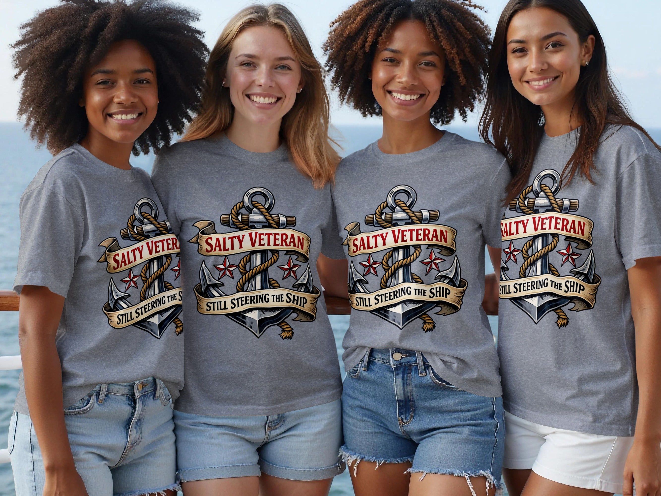 Four smiling women wear grey t-shirts with anchor and ribbon graphic and text.