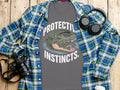 Grey t-shirt with two alligators and text "PROTECTIVE INSTINCTS".