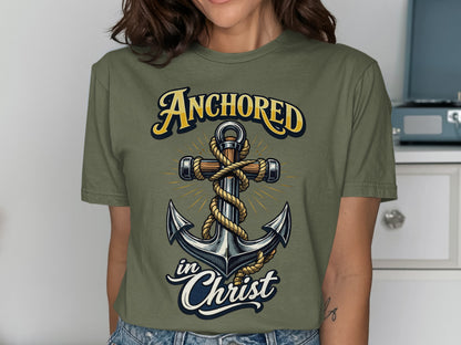 Olive green t-shirt with a graphic of an anchor, rope, and text "Anchored in Christ".