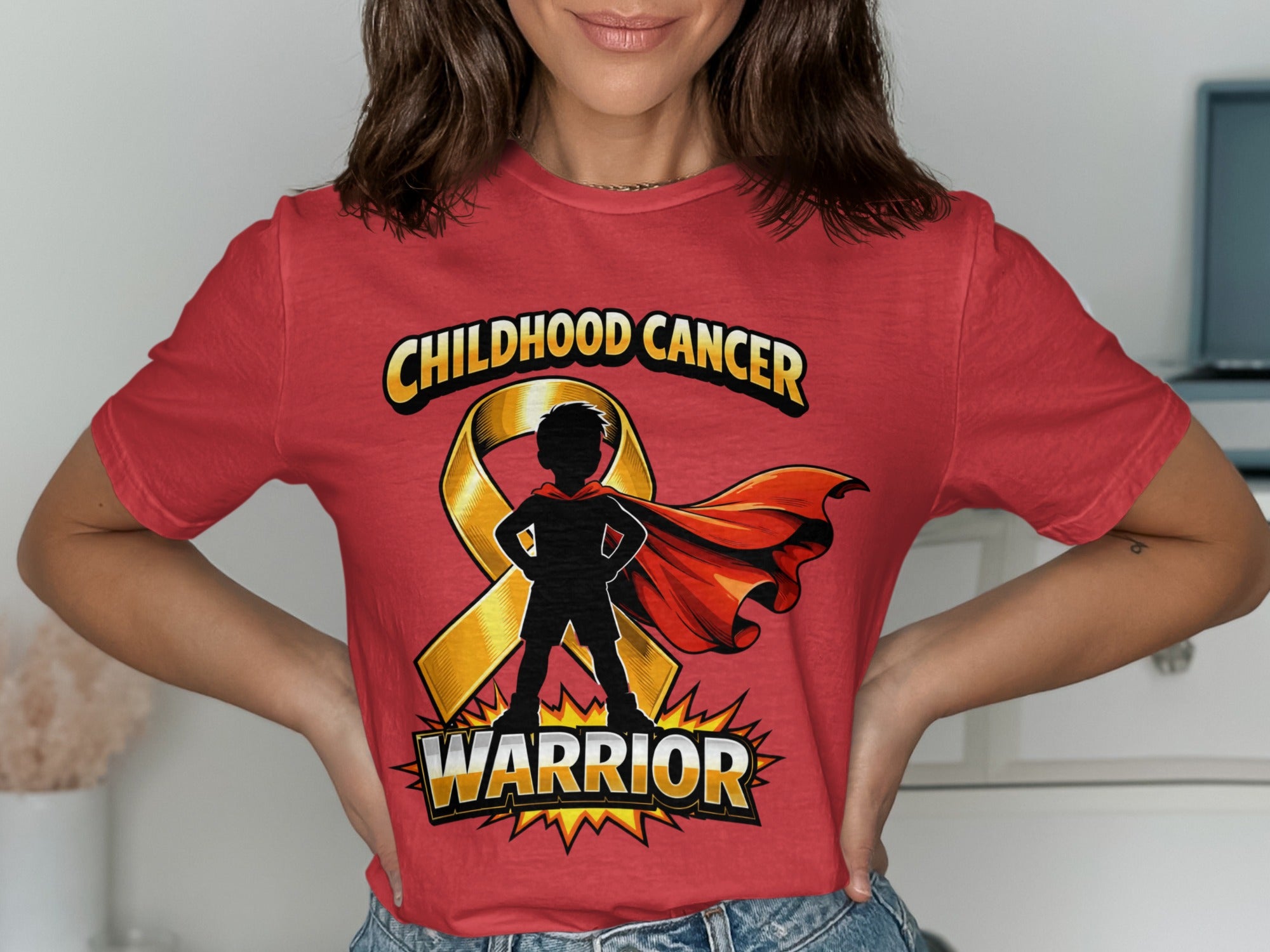 Red t-shirt with gold ribbon and silhouette of a superhero kid that says "WARRIOR."