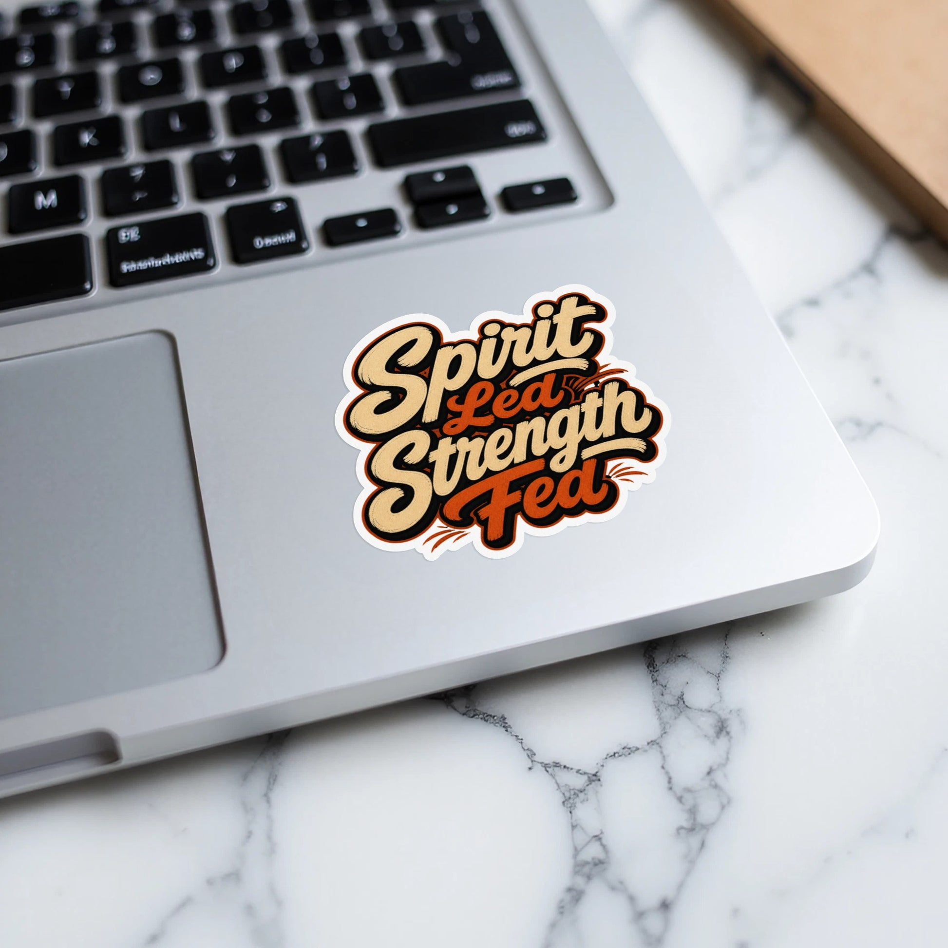 Spirit Led Strength Fed sticker on a laptop keyboard.
