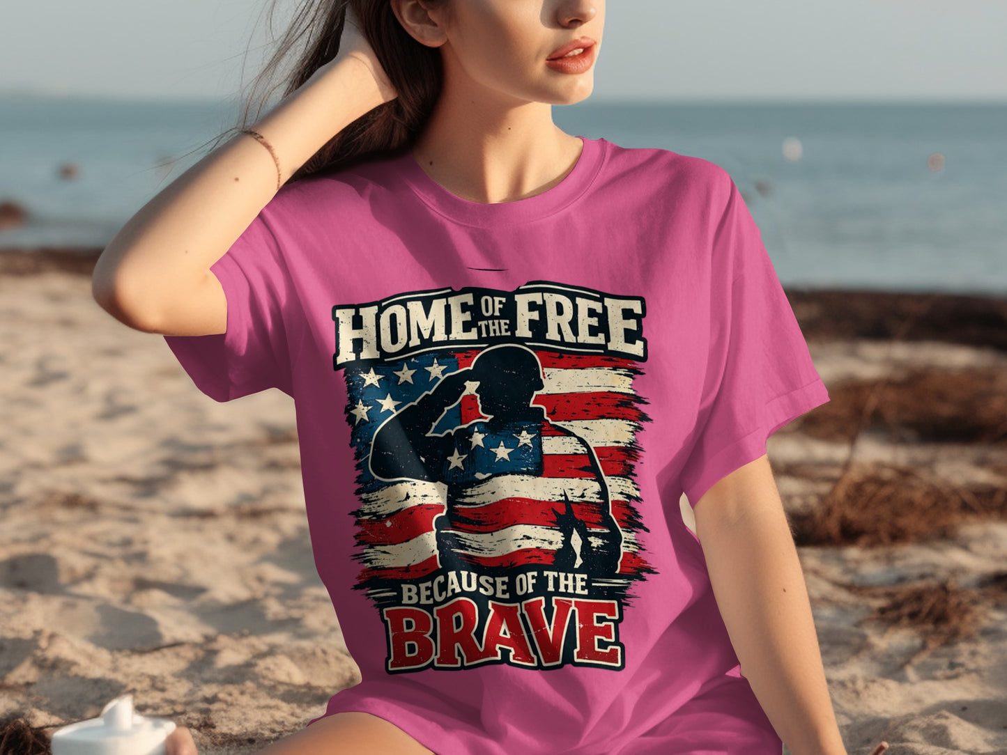 Pink t-shirt with soldier silhouette, American flag, and "Home of the Free Because of the Brave" text.