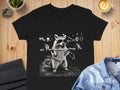 T-shirt graphic of a raccoon wearing sunglasses lifting a barbell.