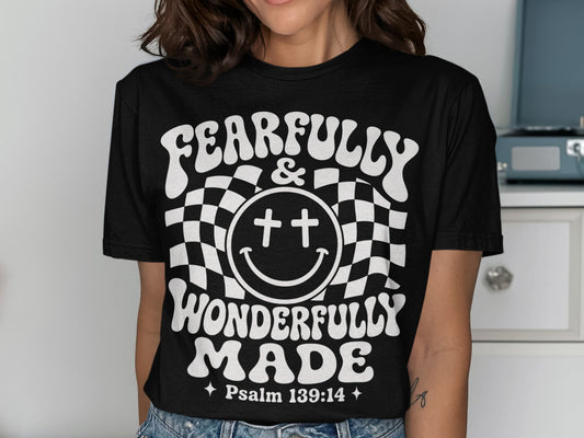 Black t-shirt with white text reading "FEARFULLY & WONDERFULLY MADE" and "Psalm 139:14".