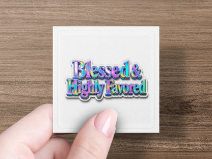 Holographic sticker with the words "Blessed & Highly Favored" held by a hand.