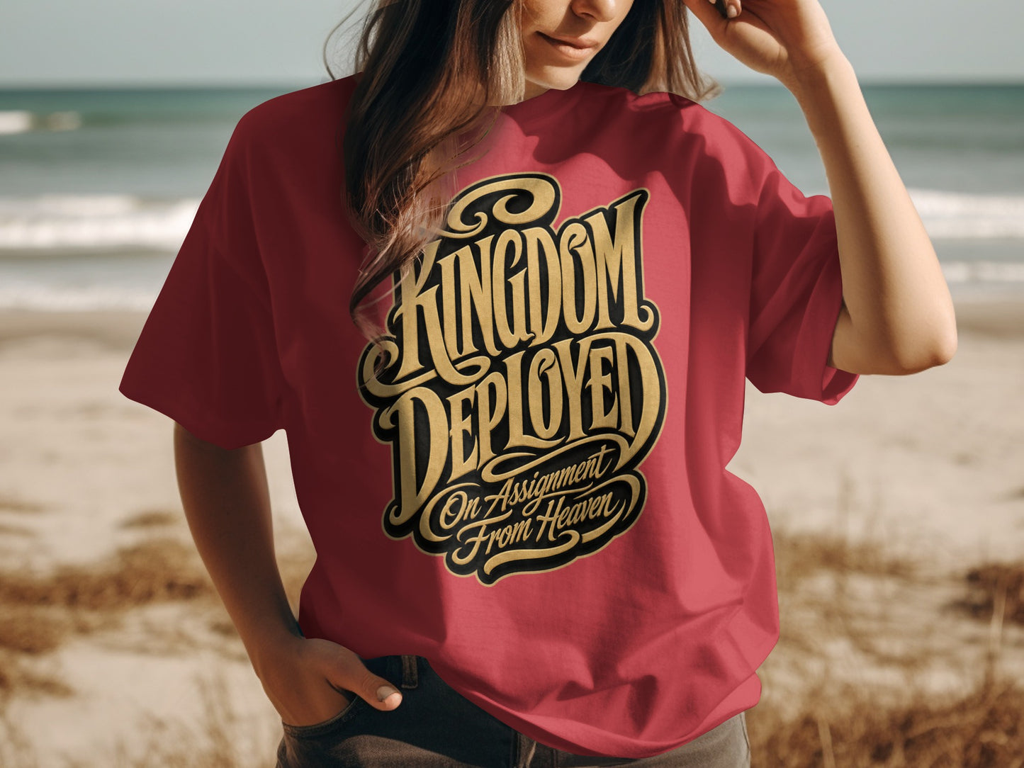 Crimson t-shirt with gold lettering that reads "Kingdom Deployed On Assignment From Heaven".