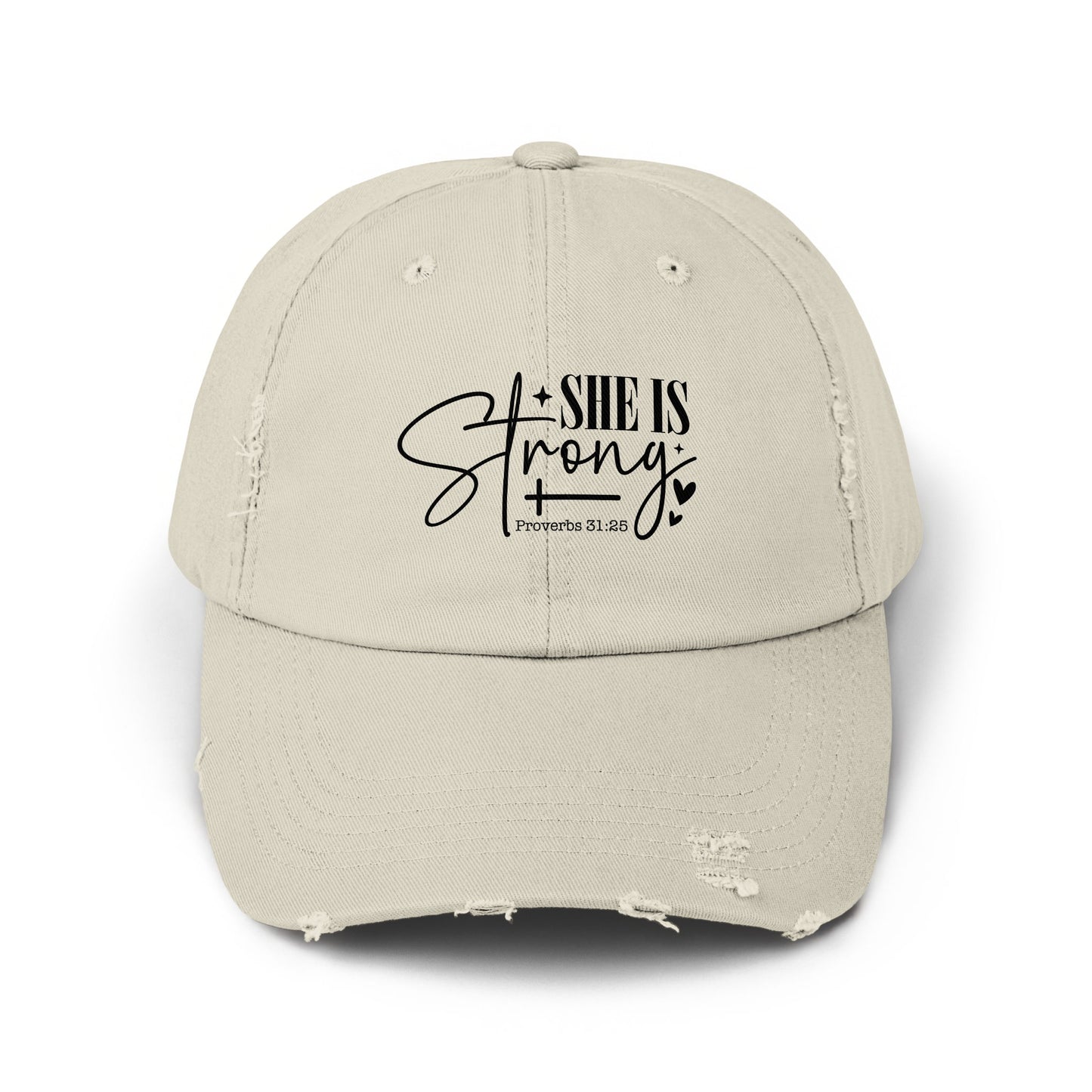 Distressed beige baseball cap with "SHE IS Strong" and "Proverbs 31:25" text.