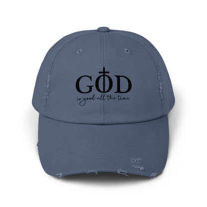 Distressed blue cap with "GOD is good all the time" text and crucifix.