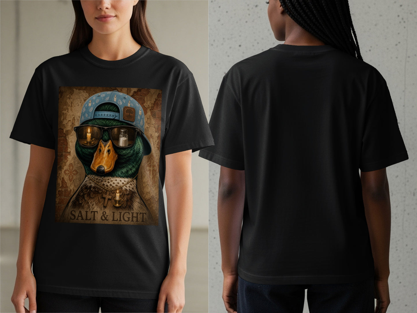Black t-shirt with a graphic of a duck wearing a hat, sunglasses with candles and salt, and a cross necklace. Text reads "SALT & LIGHT".