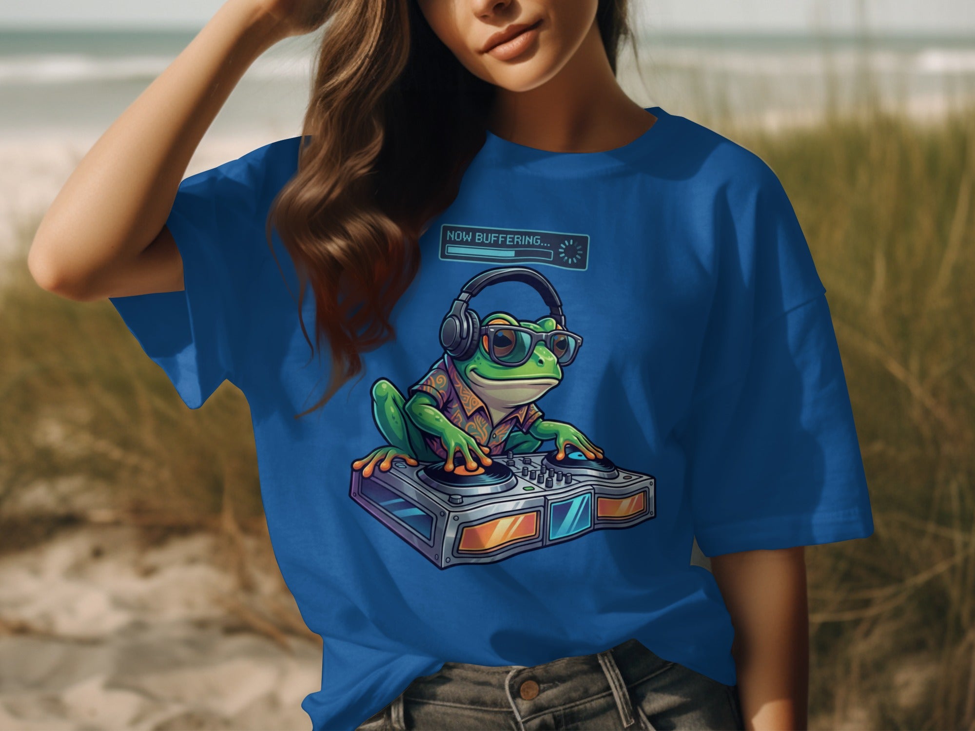Blue t-shirt with cartoon frog DJ wearing headphones and glasses, text "NOW BUFFERING..."