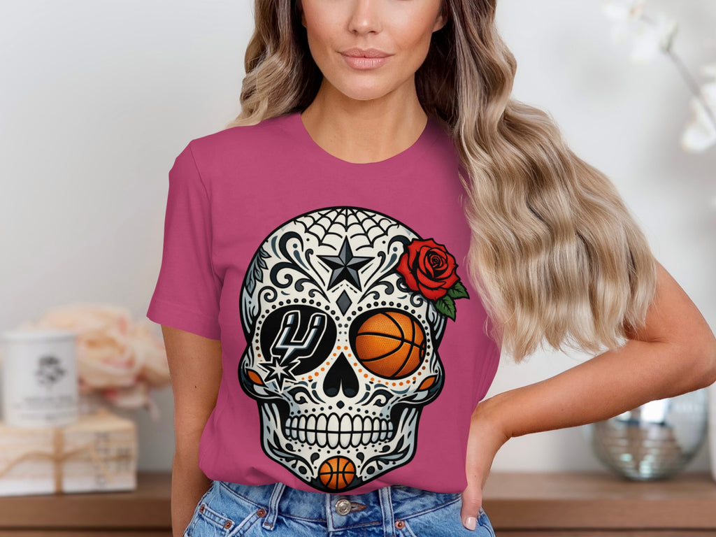 Pink t-shirt with a detailed sugar skull graphic featuring a basketball and Spurs logo.
