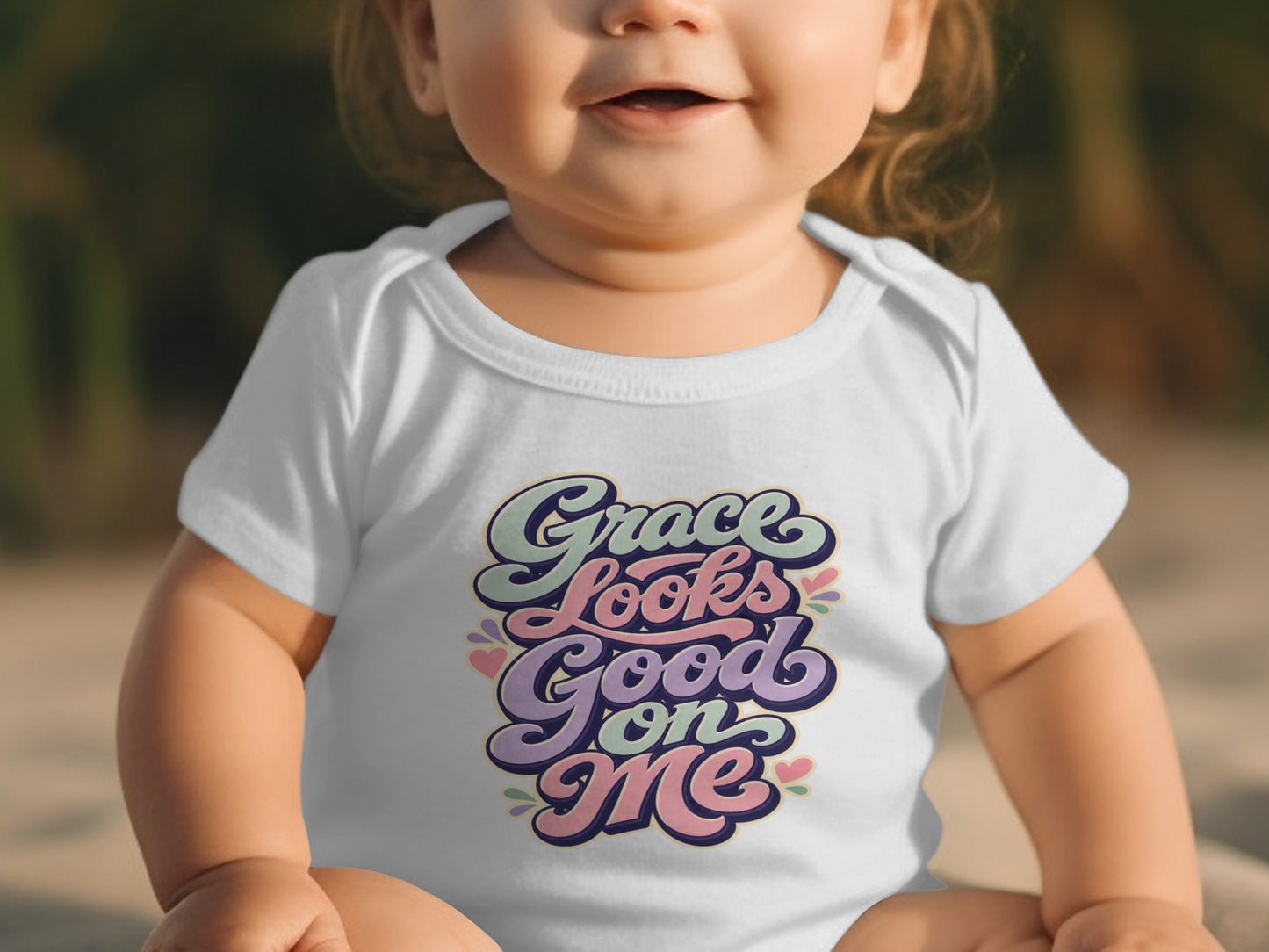 Baby wearing a white bodysuit with "Grace Looks Good on Me" text.