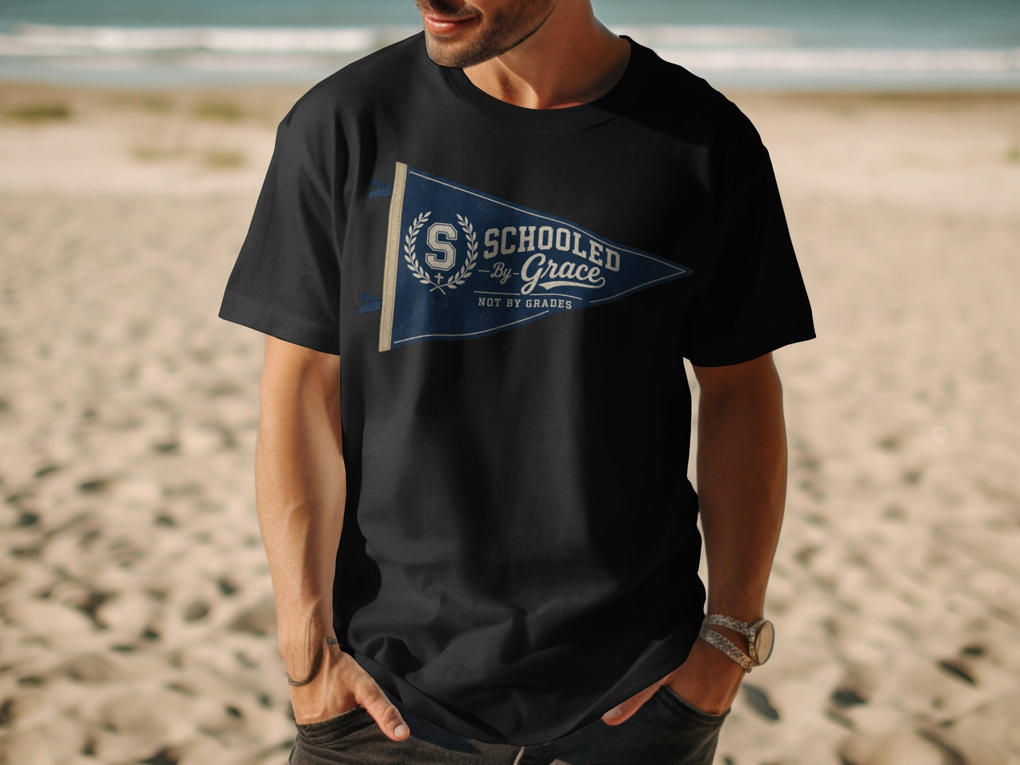 Black t-shirt with navy pennant graphic: "Schooled by Grace Not by Grades".