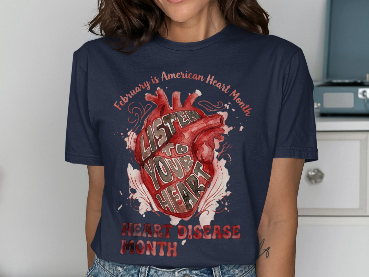 Navy t-shirt with watercolor heart art: "Listen to Your Heart" and "Heart Disease Month".
