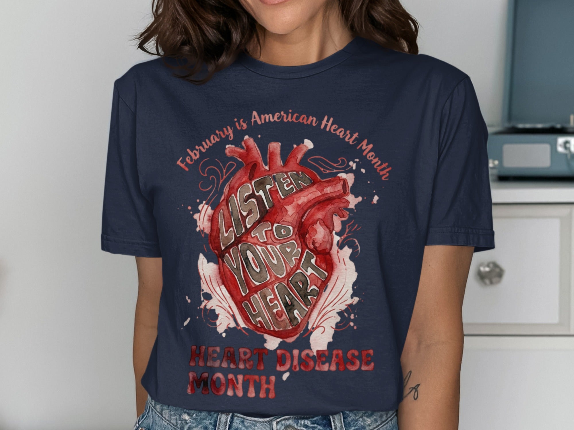 Navy t-shirt with watercolor heart art: "Listen to Your Heart" and "Heart Disease Month".