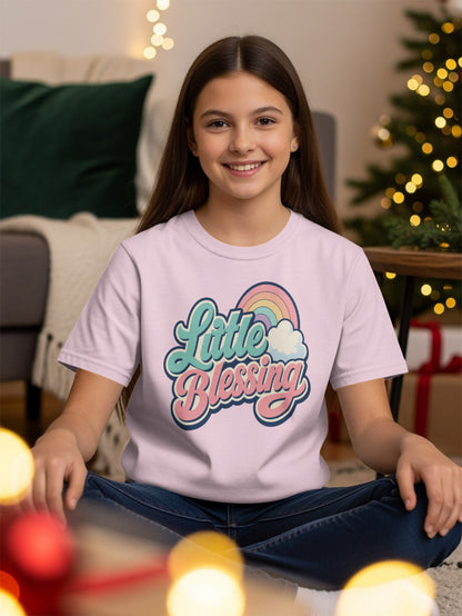Girl wearing pink t-shirt with "Little Blessing" text and rainbow graphic.