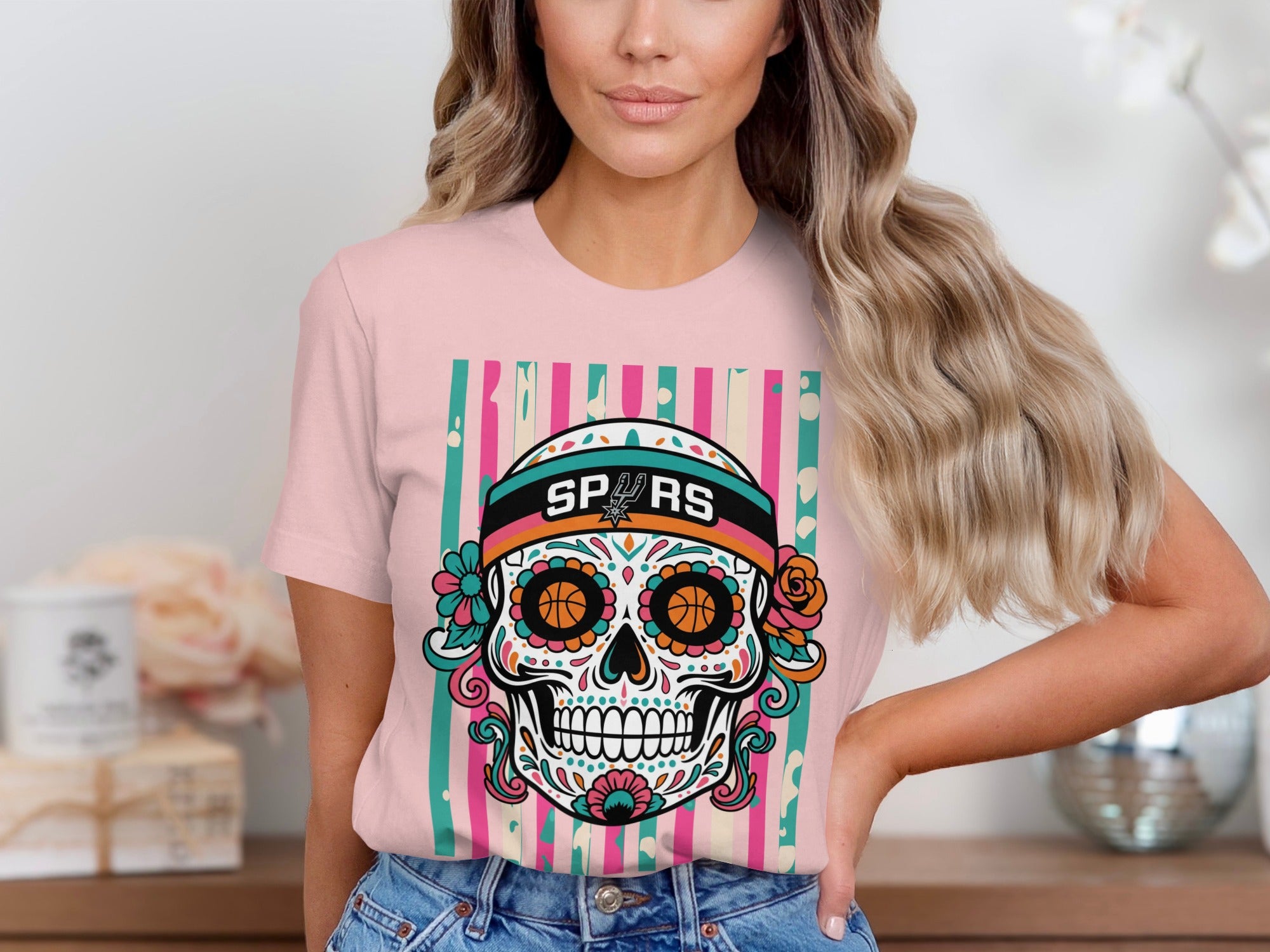 Pink t-shirt featuring a colorful sugar skull design with "SPURS" text.