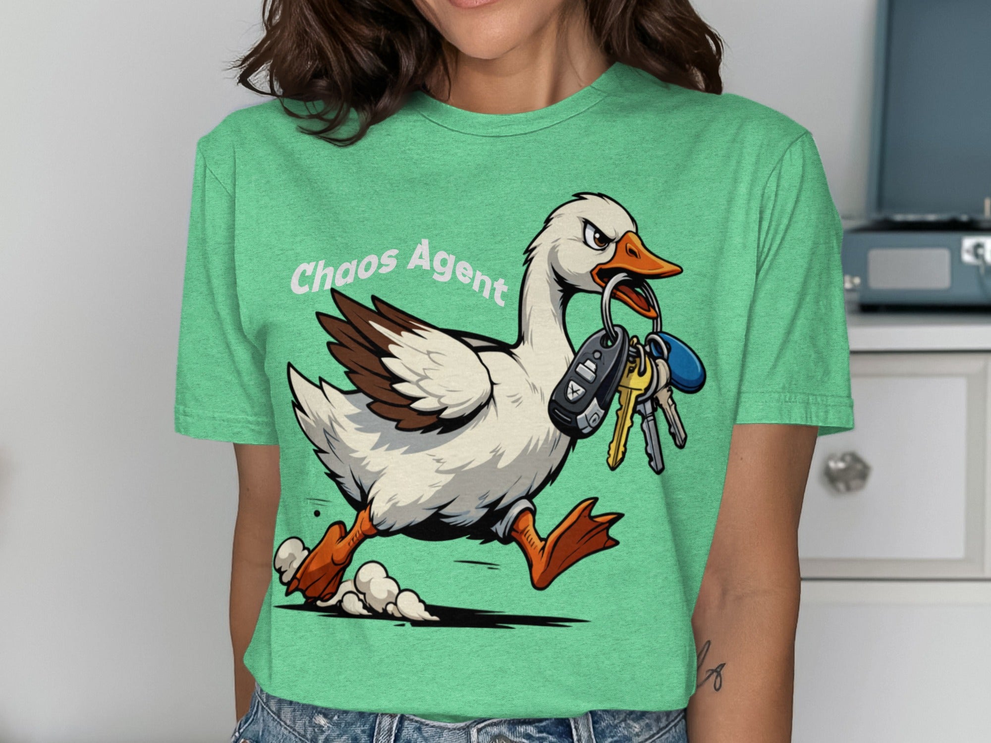 Green t-shirt with "Chaos Agent" and a goose stealing car keys.