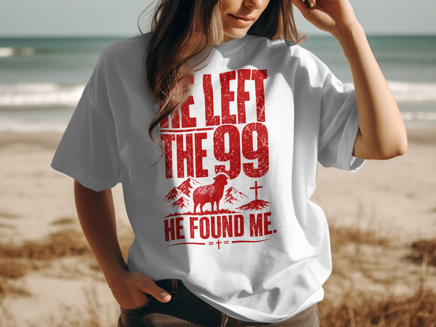 White t-shirt with red distressed text and graphic of a sheep, mountains, and cross.
