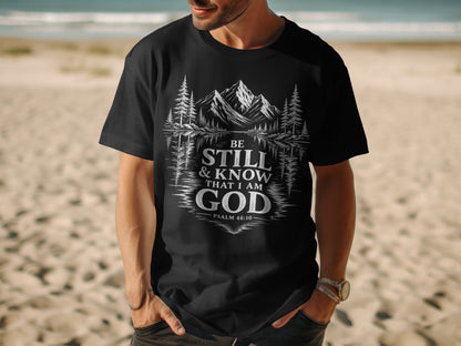 Black t-shirt with "Be Still & Know That I Am God Psalm 46:10" text and mountain landscape graphic.