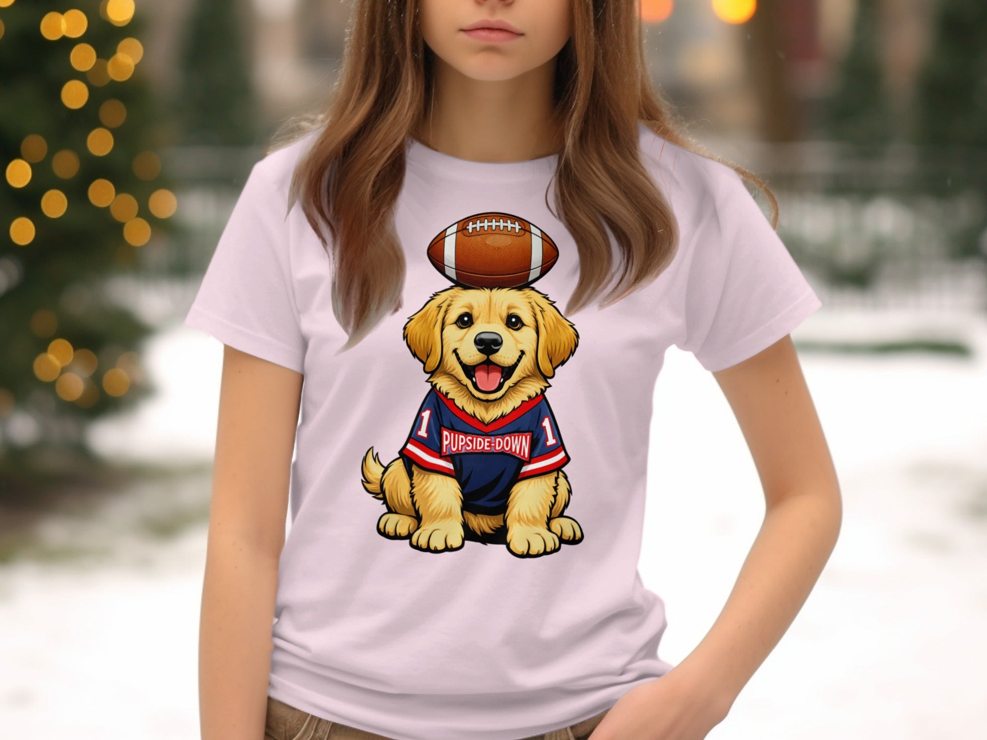 Golden retriever puppy with football on head, wearing "PUPSIDE-DOWN" jersey.