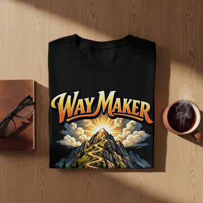Black t-shirt with "Way Maker" text over a winding mountain path at sunrise.