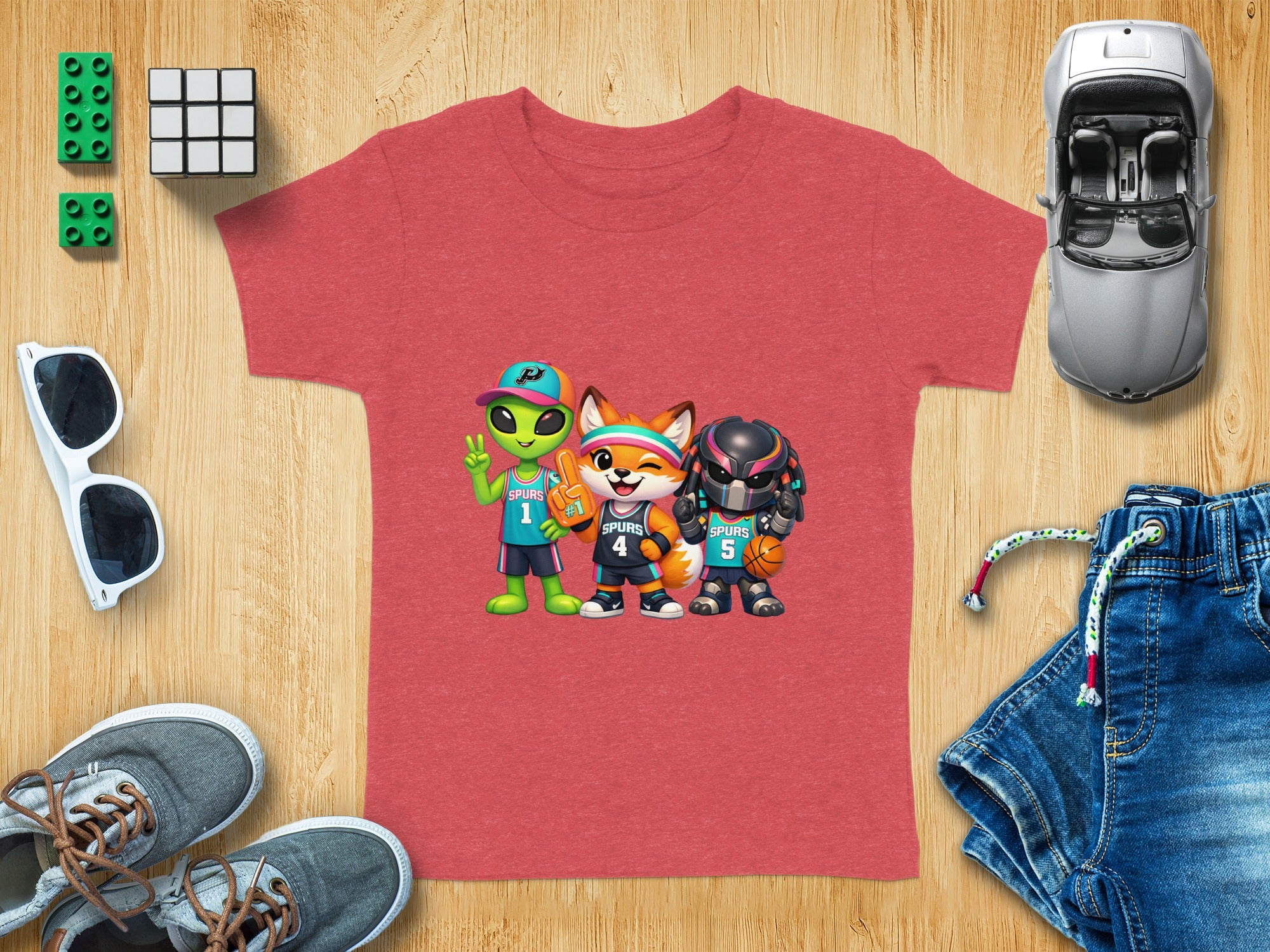 Red t-shirt with cartoon alien, fox, and robot characters in basketball uniforms.