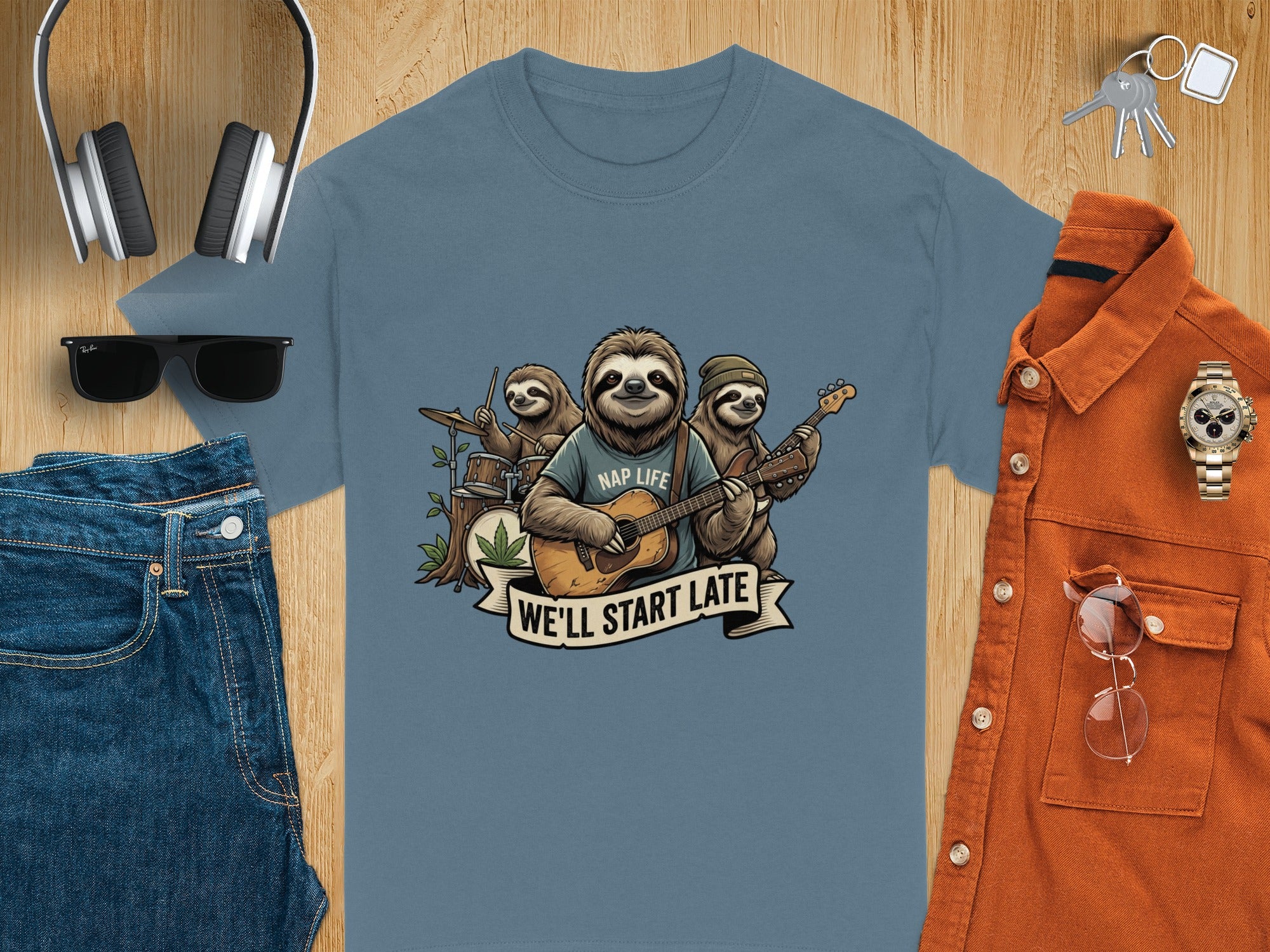 Sloth band graphic with "Nap Life" and "We'll Start Late" text on a blue t-shirt.