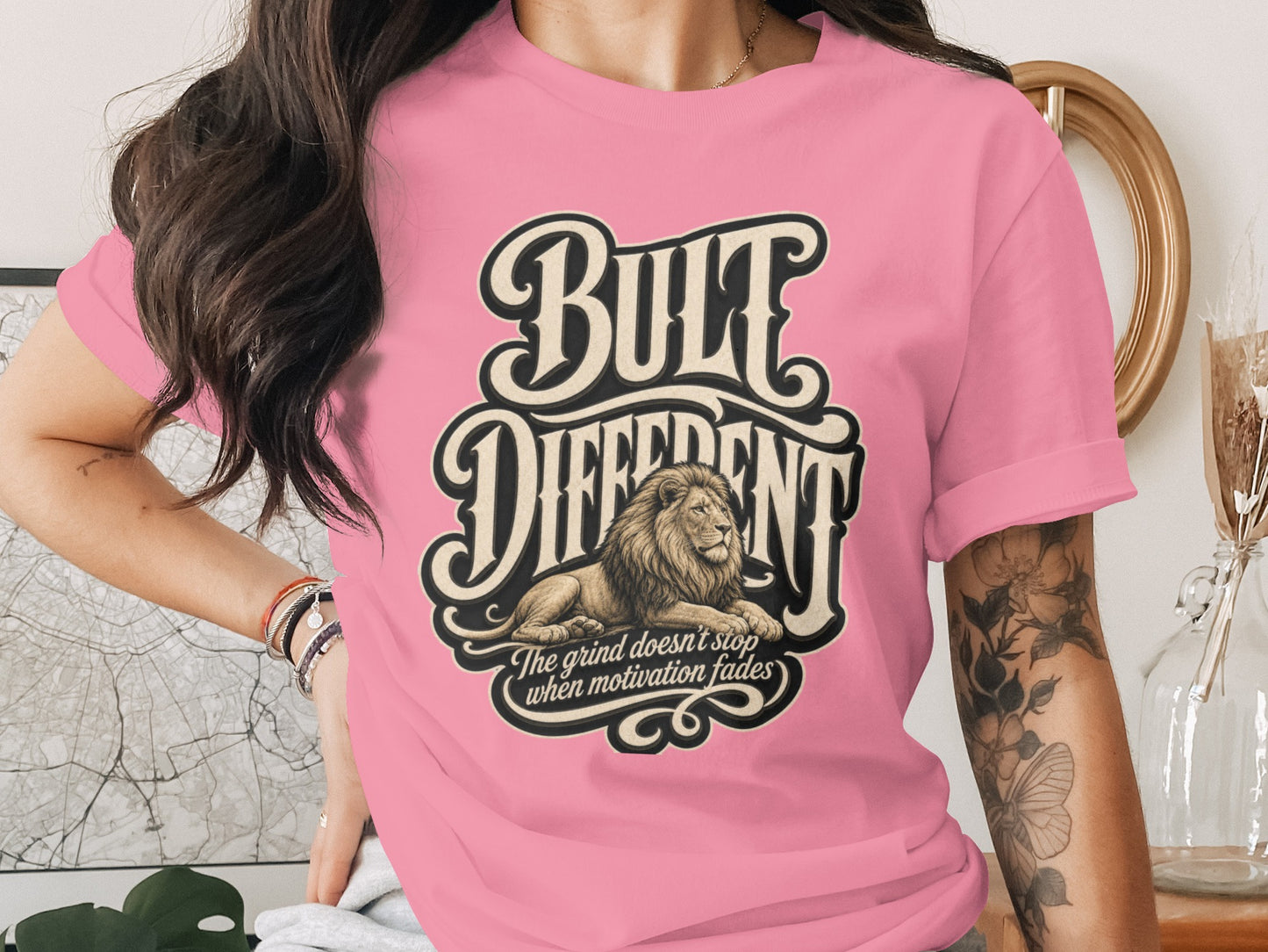 Pink t-shirt with large "BUILT DIFFERENT" text and a lion.