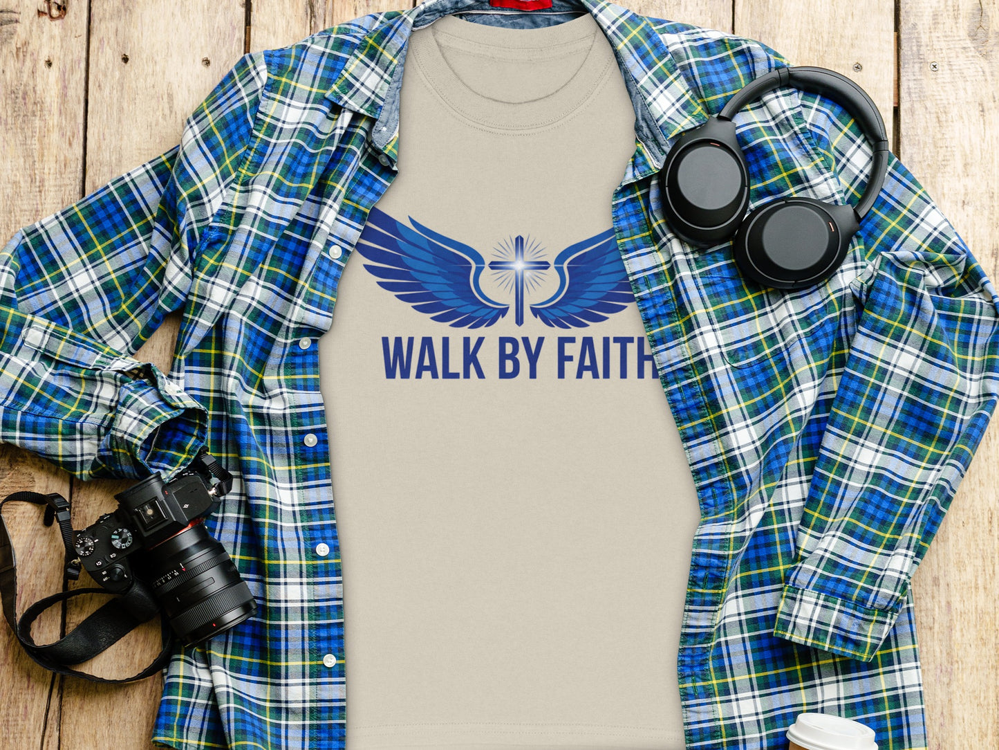 Tan t-shirt with "WALK BY FAITH" and blue wings with cross graphic.