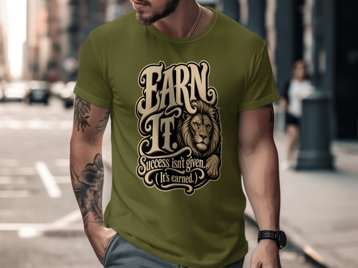Olive green t-shirt with "EARN IT. Success isn't given. (It's earned.)" and a lion graphic.