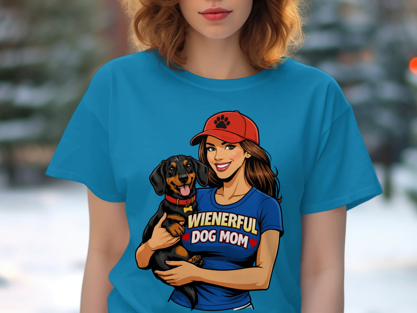 Woman wearing blue t-shirt with dog and "Wienerful Dog Mom" text.