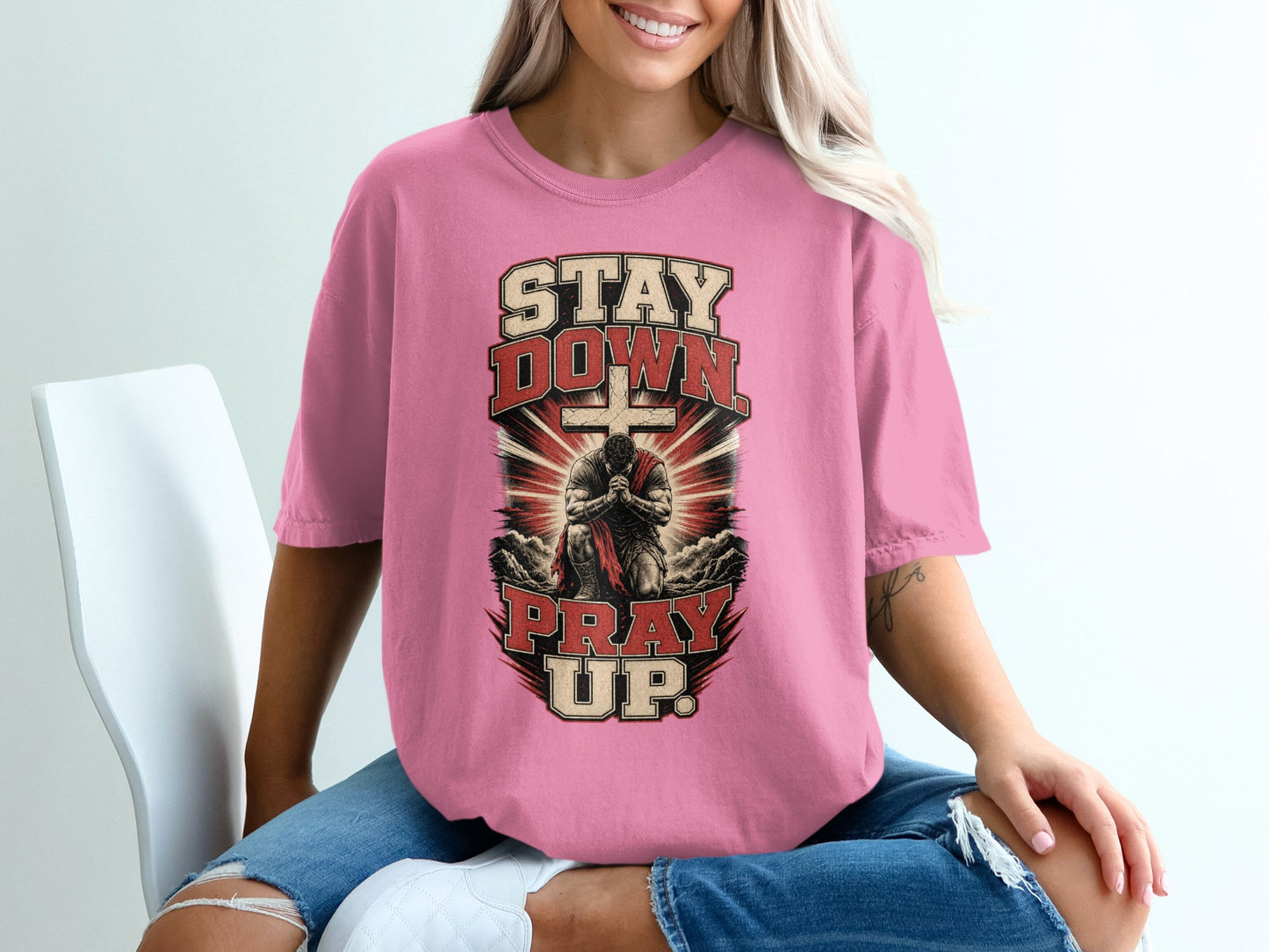 Graphic tee with text "STAY DOWN PRAY UP" and praying figure.