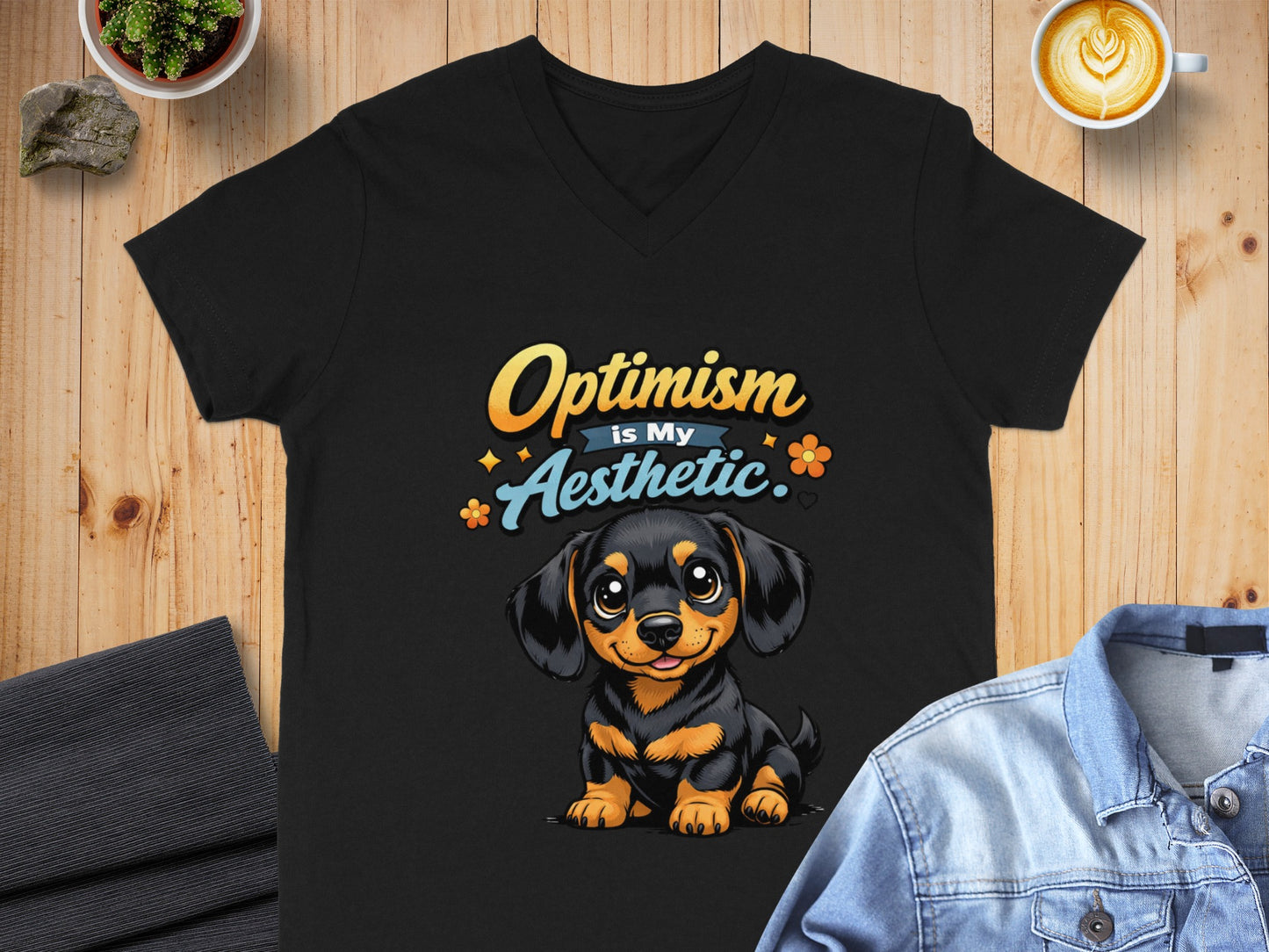 Black t-shirt with a cartoon dog graphic and "Optimism is My Aesthetic" text.