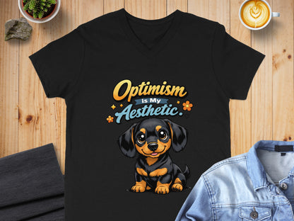 Black t-shirt with a cartoon dog graphic and "Optimism is My Aesthetic" text.