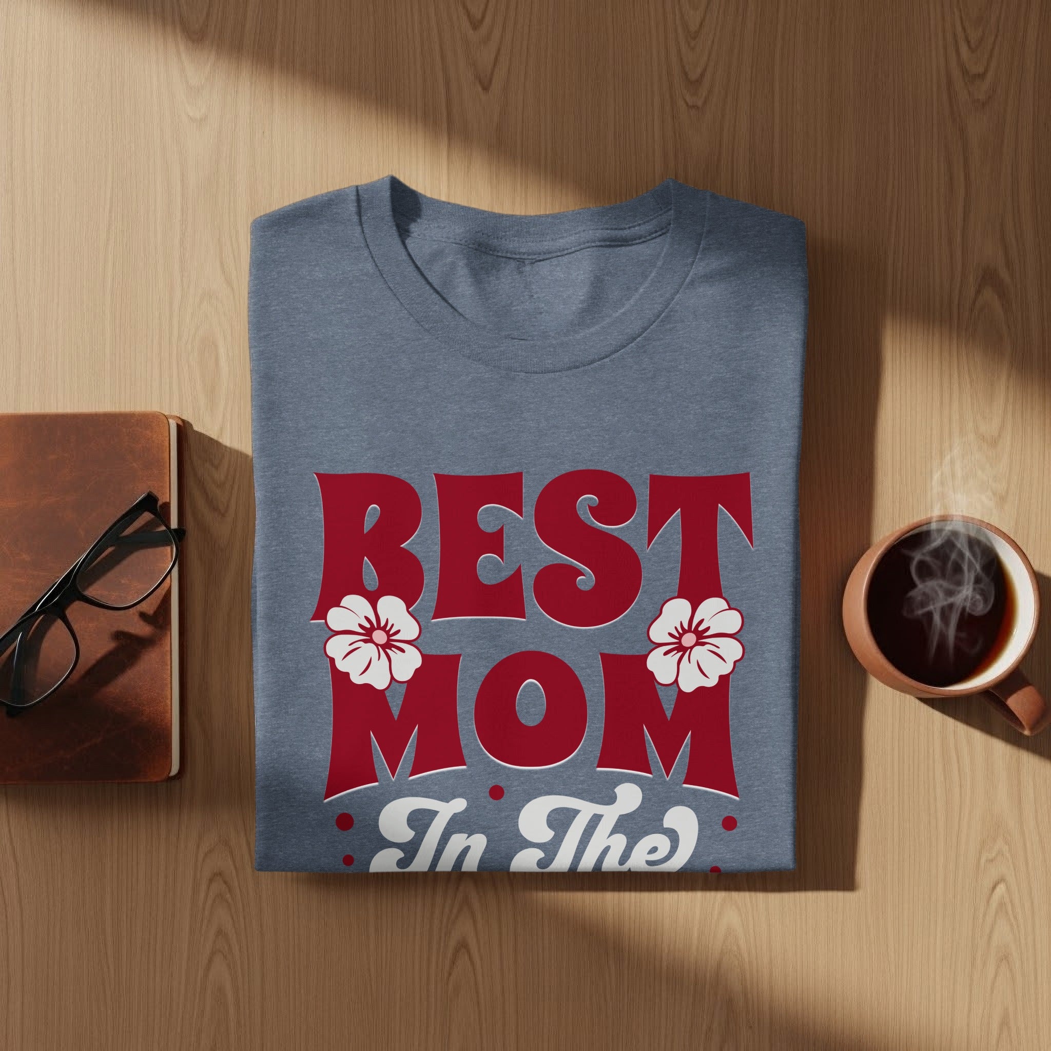 Blue t-shirt with "BEST MOM In The" text and floral accents.