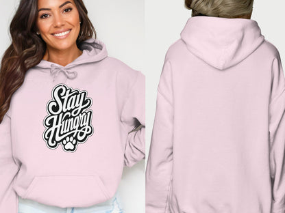 Pink hoodie with "Stay Hungry" text and paw print graphic on front.