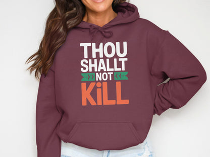 Maroon hoodie with "THOU SHALT NOT KILL" graphic print.
