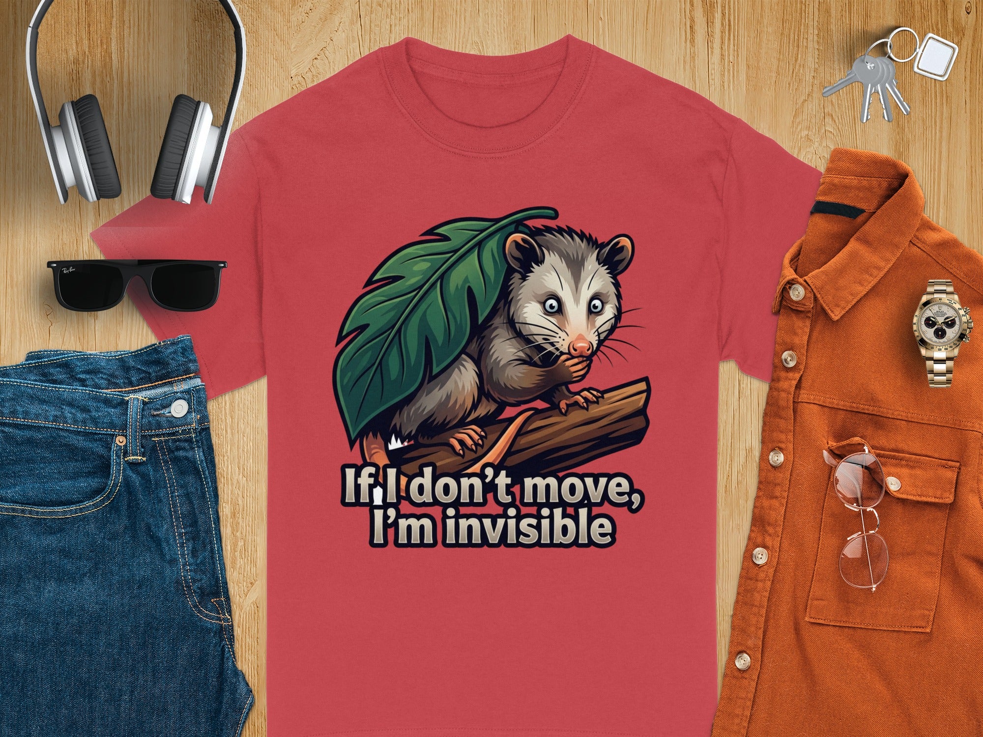 Red t-shirt with opossum graphic and "If I don't move, I'm invisible" text.