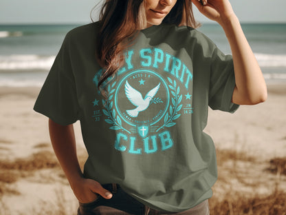 Green t-shirt with "Holy Spirit Club" text, dove, and cross emblem.