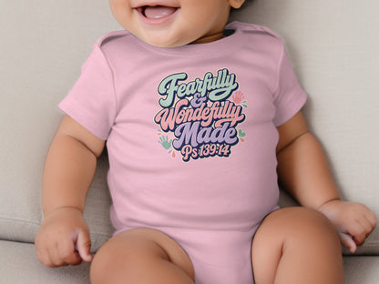 Pink baby onesie with "Fearfully & Wonderfully Made Ps139:14" text and handprints.