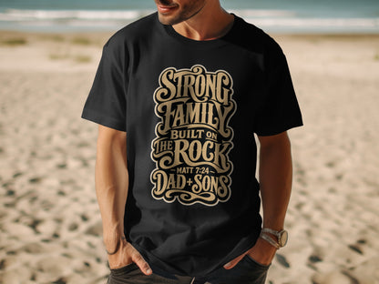 Black t-shirt with "Strong Family Built on The Rock Matt 7:24 Dad + Sons" text.