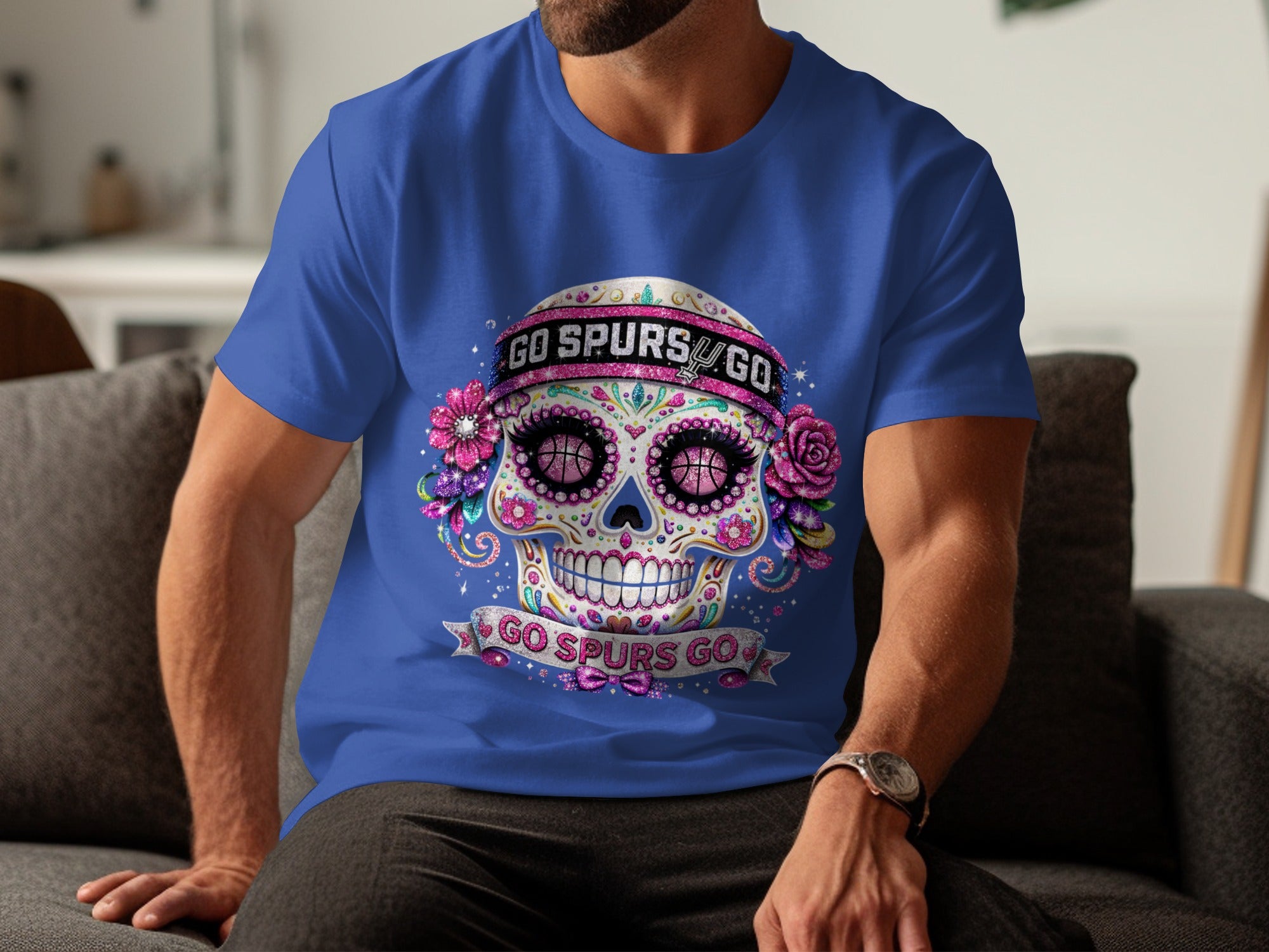 Day of the dead skull with basketball eyes, "Go Spurs Go" text on blue t-shirt.