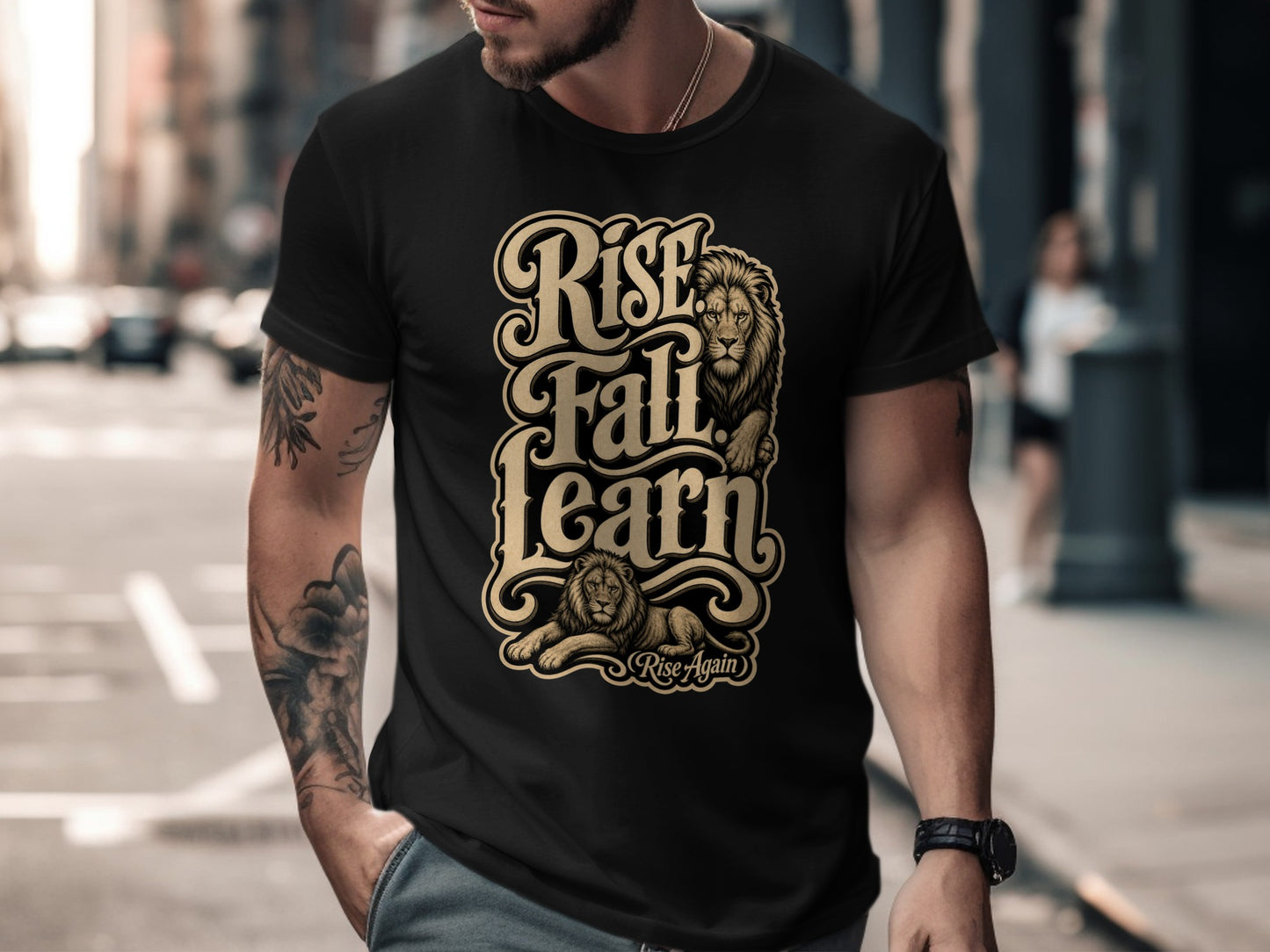Black t-shirt with gold lettering "Rise Fall Learn" and lion graphics.