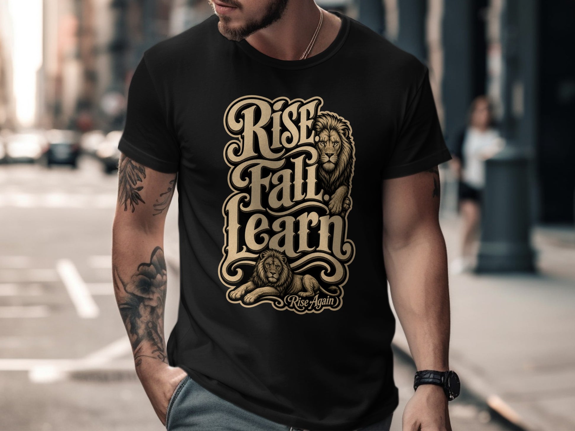 Black t-shirt with gold lettering "Rise Fall Learn" and lion graphics.