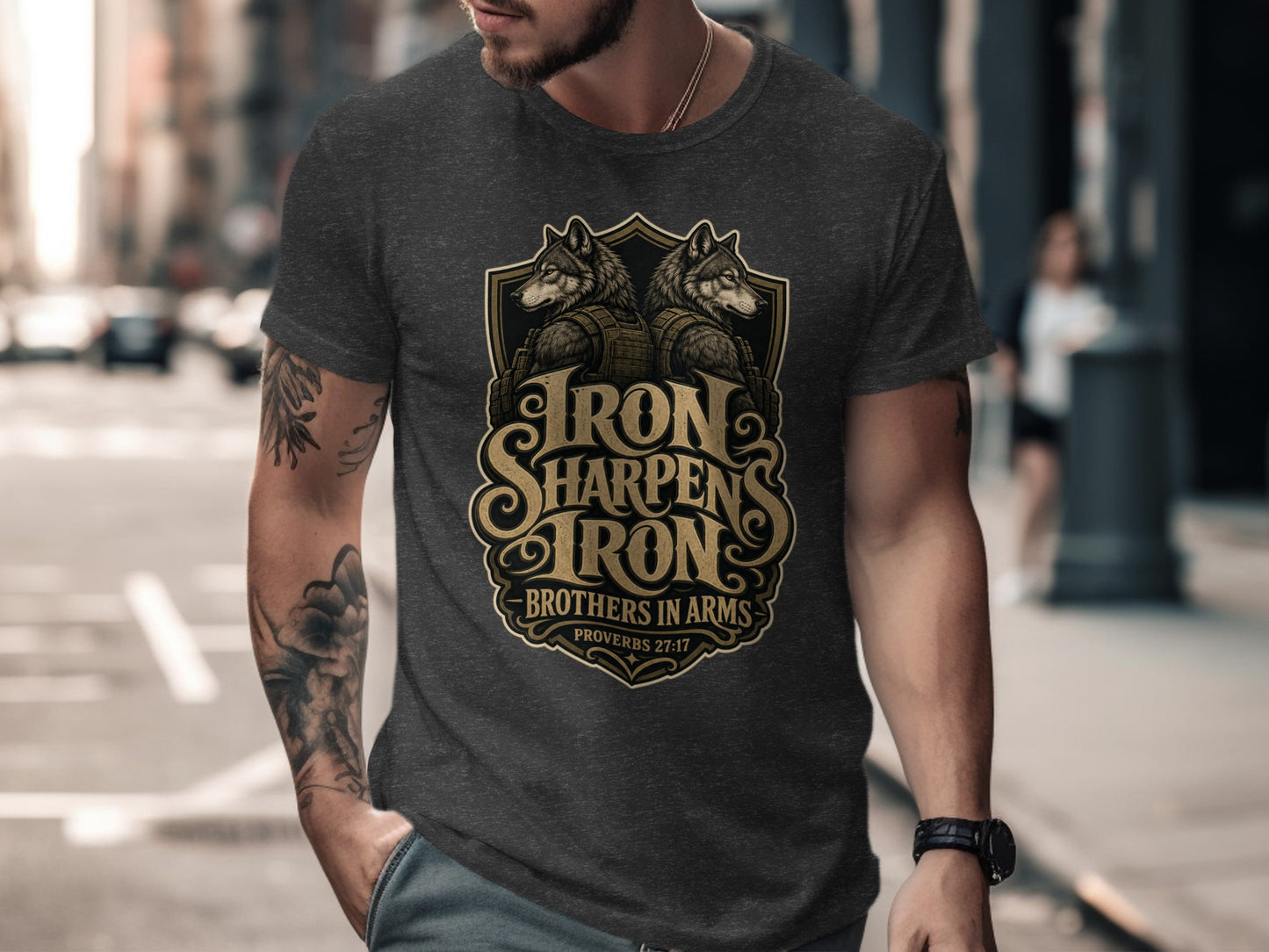 Dark grey t-shirt with a graphic of two wolves and the text "Iron Sharpens Iron Brothers in Arms Proverbs 27:17".