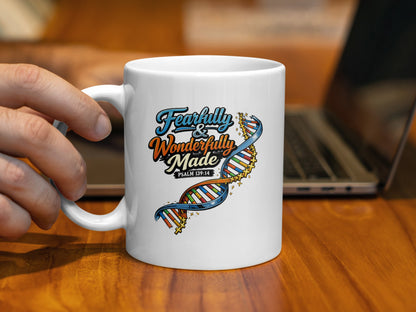 White mug with "Fearfully & Wonderfully Made Psalm 139:14" and DNA graphic.